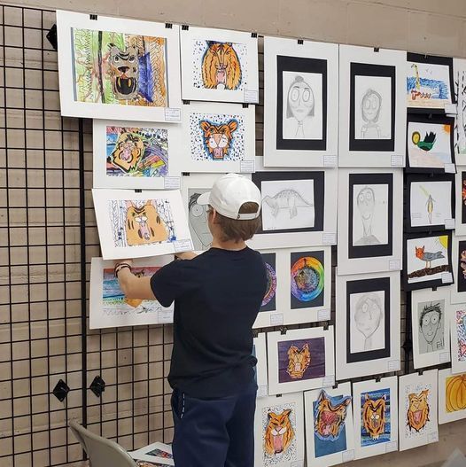 Kid hanging pictures